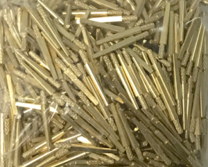 Close up shot of tapered brass pins with textured bases