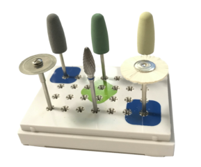 Small kit containing three acrylic polishers, diamond disc, carbide lab cutter, and bristle brush in small plastic container